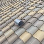 Robertson Roofing team performing tile roof repairs in Fort Myers, focusing on proper roof ventilation to prevent moisture damage.