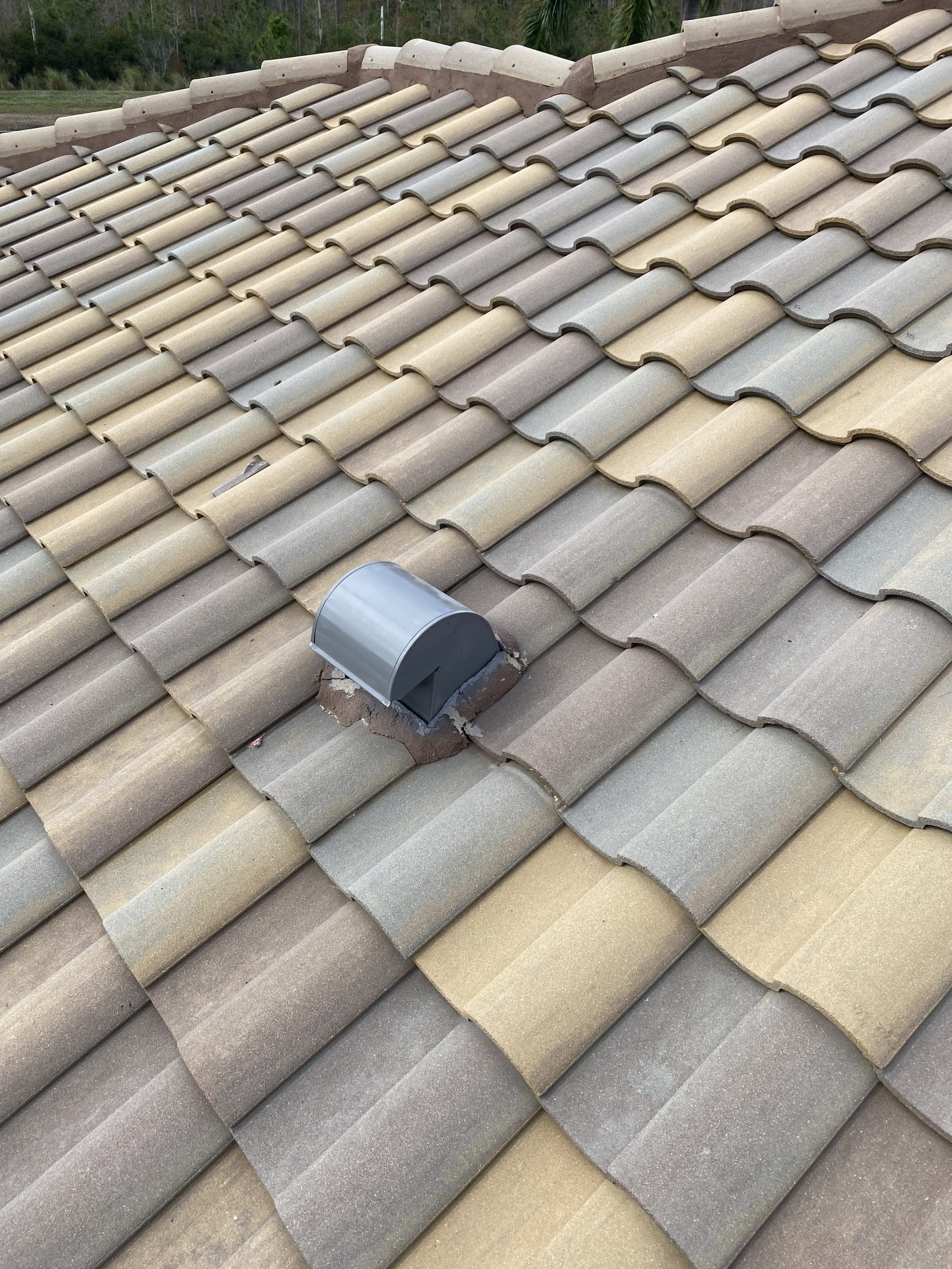 Robertson Roofing team performing tile roof repairs in Fort Myers, focusing on proper roof ventilation to prevent moisture damage.
