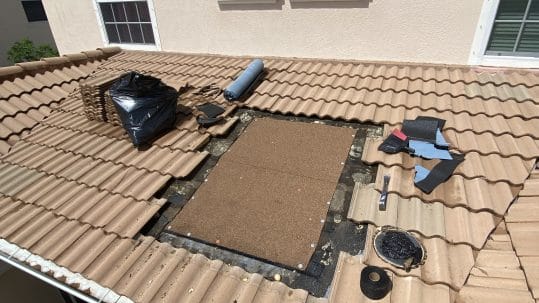 Professional roofers repairing a storm damaged roof in Fort Myers, FL.