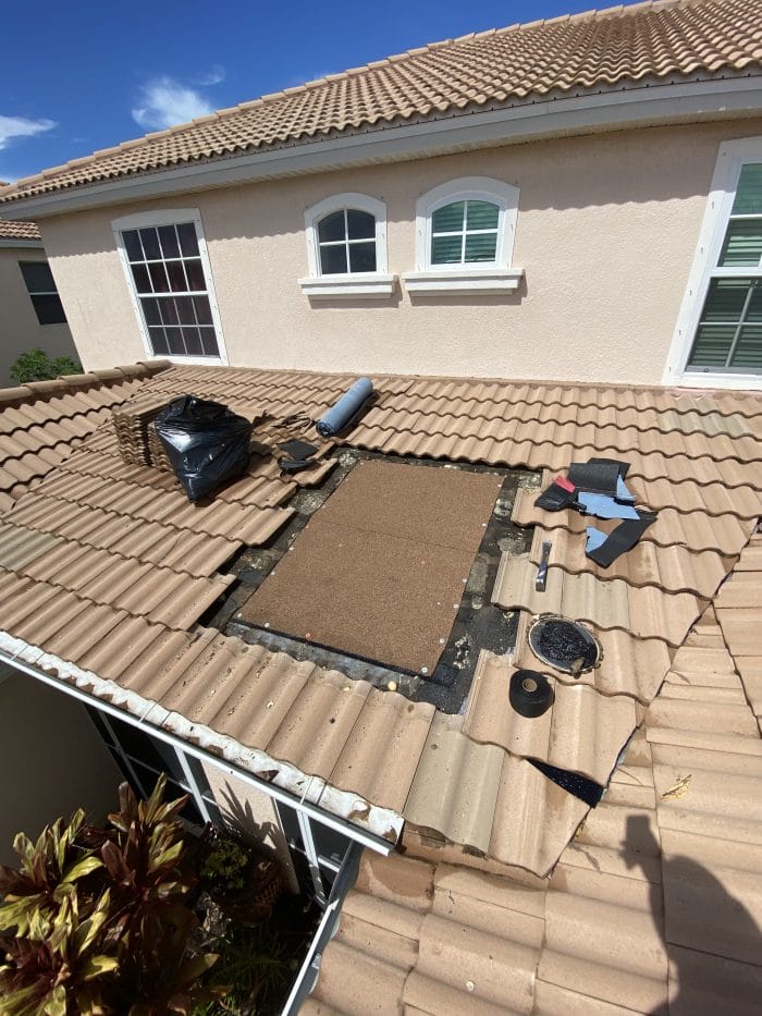 Professional roofers repairing a storm damaged roof in Fort Myers, FL.