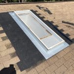 Robertson Roofing team repairing shingle roof skylight flashing on a home in Fort Myers, Florida.