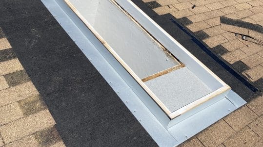 Robertson Roofing team repairing shingle roof skylight flashing on a home in Fort Myers, Florida.