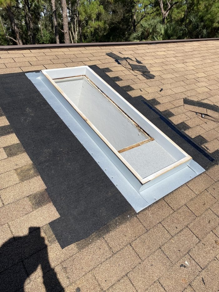 Robertson Roofing team repairing shingle roof skylight flashing on a home in Fort Myers, Florida.